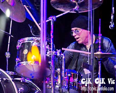 Photo of Ben Gramm on Drums, with Lou Gramm in concert at the CNE Bandshell. Photo credit ccvic.zenfolio.com