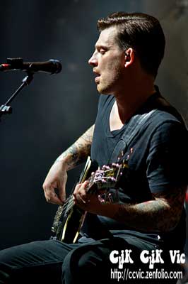 Photo of Dean Back on Bass with Theory of a Deadman performing at the CNE Bandshell. Photo credit ccvic.zenfolio.com