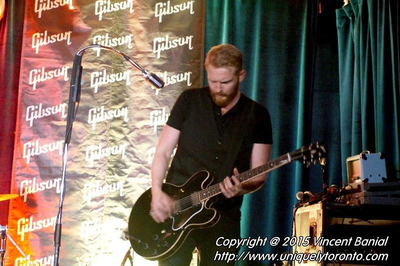 Photo of Jonny Fox playing guitar with the band "The StandStills". PHoto credit Vincent Banial