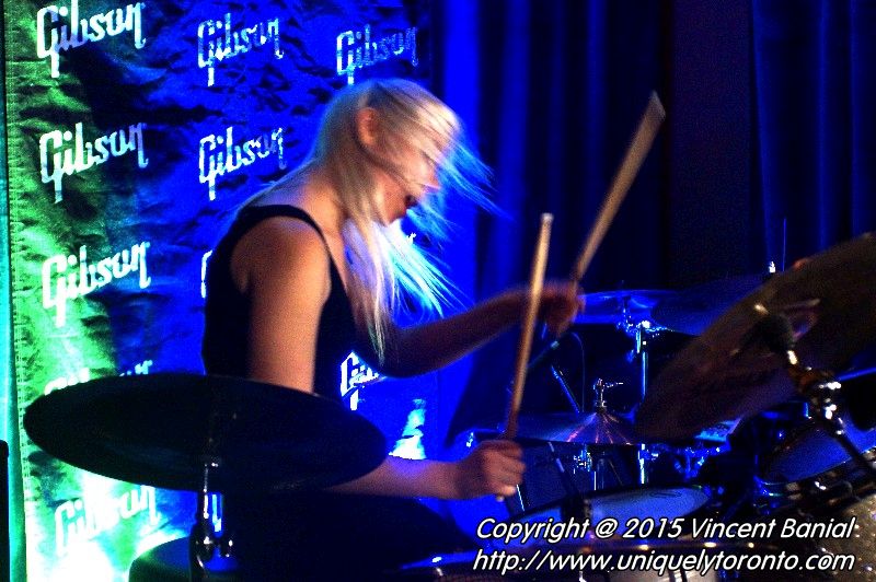 Photo of Renée Couture playing the drums in the band "The StandStills". Photo credit Vincent Banial