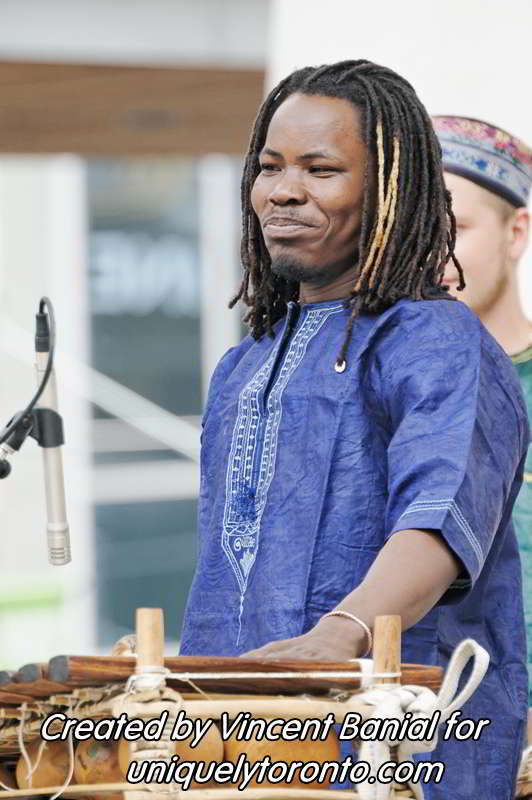Photo of Katenan Dioubate - CHEKA performing at Yonge Dundas Square in Toronto on May 25 2015. Photo credit Vincent Banial